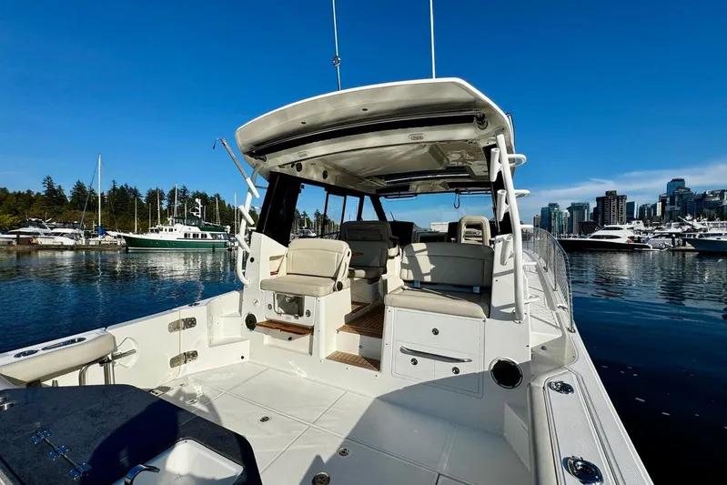 Days Ahead Yacht Photos Pics 2022 Boston Whaler 405 Conquest boat docked in a marina with city skyline.