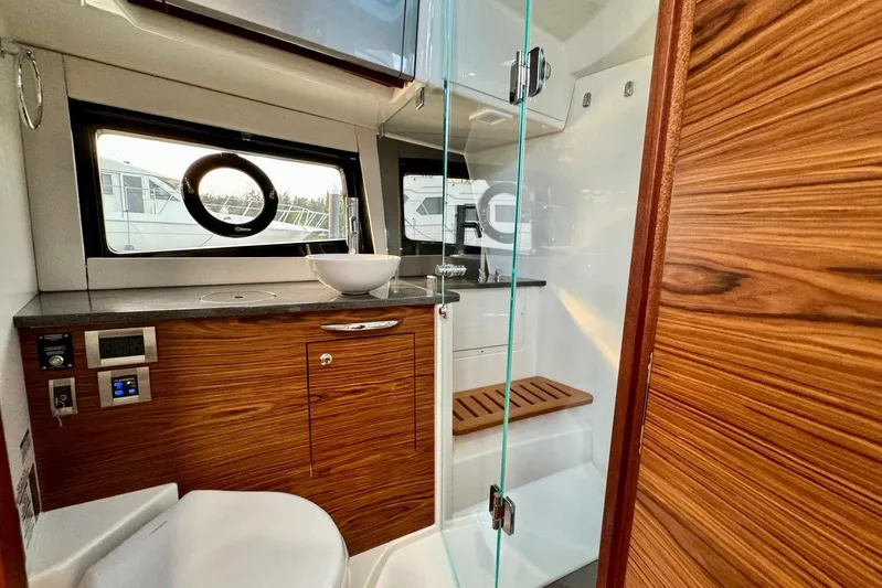 Days Ahead Yacht Photos Pics Luxurious bathroom interior of 2022 Boston Whaler 405 Conquest yacht with wood accents.