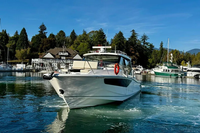 Days Ahead Yacht Photos Pics 2022 Boston Whaler 405 Conquest yacht cruising in a scenic marina setting.