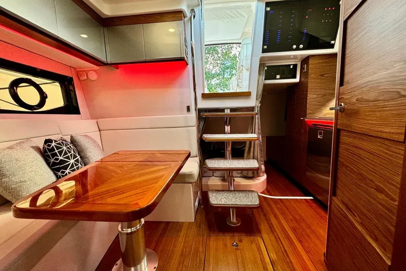 Days Ahead Yacht Photos Pics Luxurious interior of 2022 Boston Whaler 405 Conquest with wooden table and modern design.