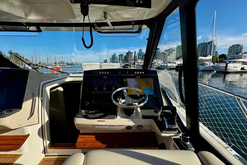 Days Ahead Yacht Photos Pics Interior view of 2022 Boston Whaler 405 Conquest yacht cockpit with marina backdrop.