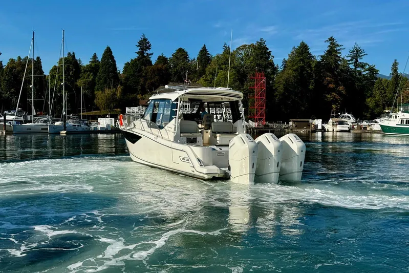 Days Ahead Yacht Photos Pics 2022 Boston Whaler 405 Conquest boat with four engines in a marina setting.
