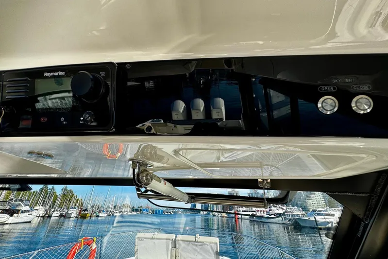 Days Ahead Yacht Photos Pics 2022 Boston Whaler 405 Conquest helm with Raymarine controls, marina view in background.