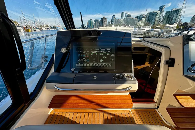 Days Ahead Yacht Photos Pics 2022 Boston Whaler 405 Conquest helm with advanced navigation system, docked in marina.