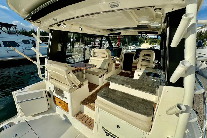 Days Ahead Yacht Photos Pics 2022 Boston Whaler 405 Conquest interior with seating and fishing rod holders at marina.