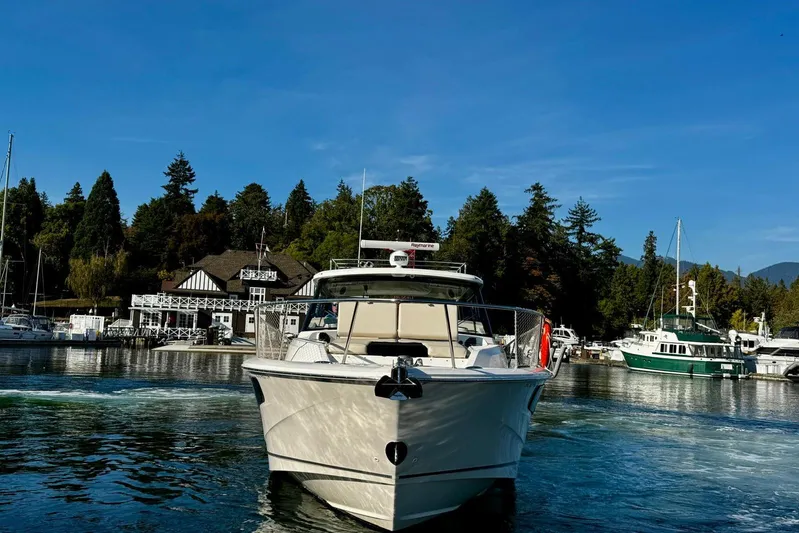 Days Ahead Yacht Photos Pics Boston Whaler 405 Conquest 2022 boat docked in scenic marina with trees and blue sky.