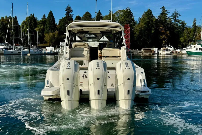 Days Ahead Yacht Photos Pics 2022 Boston Whaler 405 Conquest with quad 600 V12 engines in a marina setting.