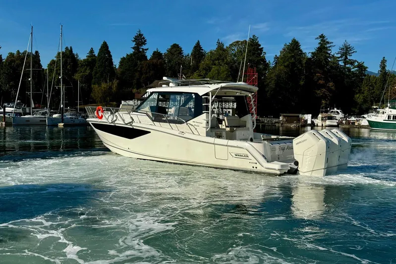 Days Ahead Yacht Photos Pics 2022 Boston Whaler 405 Conquest cruising in a scenic marina setting.
