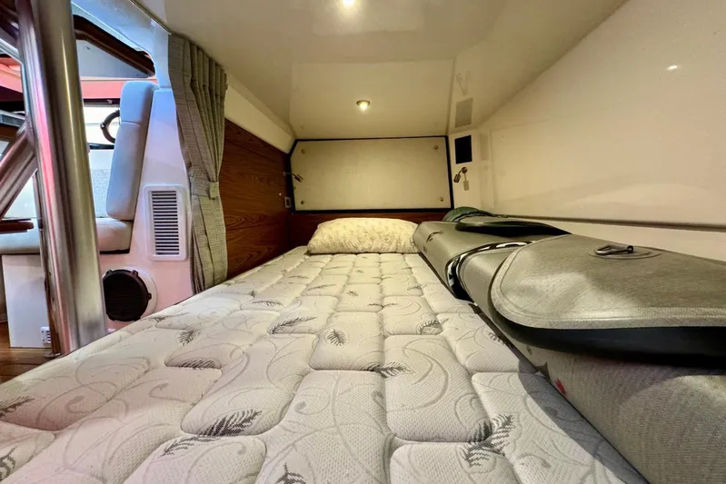 Days Ahead Yacht Photos Pics 2022 Boston Whaler 405 Conquest cabin interior with bed and surfboard storage.