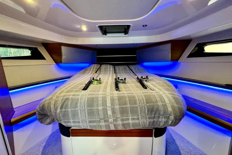 Days Ahead Yacht Photos Pics Interior cabin of 2022 Boston Whaler 405 Conquest with fishing rods on bed.