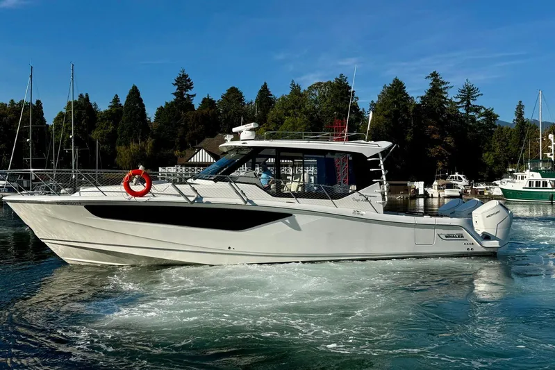 Days Ahead Yacht Photos Pics 2022 Boston Whaler 405 Conquest boat cruising in a scenic marina setting.