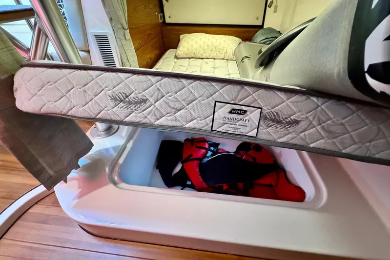 Days Ahead Yacht Photos Pics Interior of 2022 Boston Whaler 405 Conquest showing a bed with storage compartment.