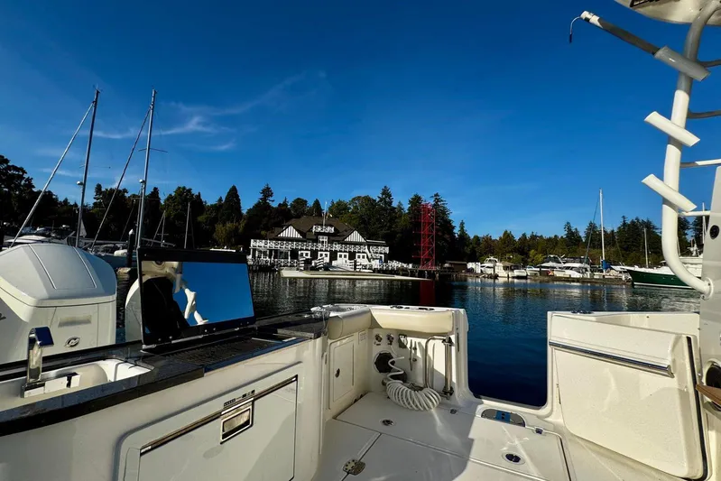 Days Ahead Yacht Photos Pics Boston Whaler 405 Conquest 2022 in scenic marina with clear blue sky.
