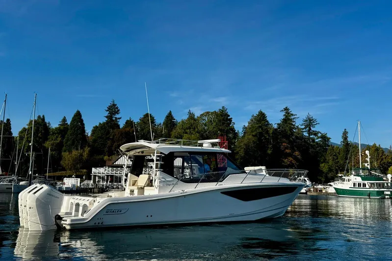 Days Ahead Yacht Photos Pics 2022 Boston Whaler 405 Conquest boat docked in a scenic marina setting.