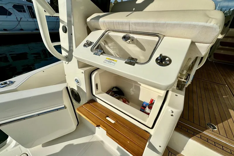 Days Ahead Yacht Photos Pics 2022 Boston Whaler 405 Conquest boat interior with storage compartment open.