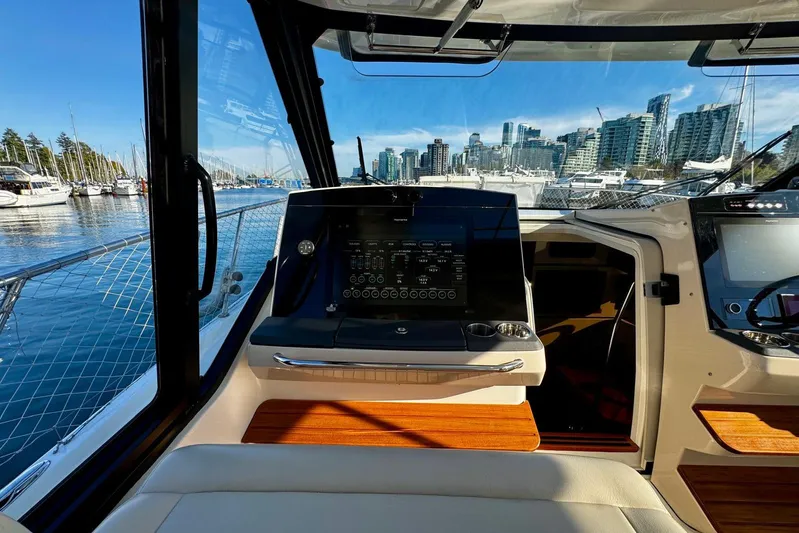 Days Ahead Yacht Photos Pics Interior view of 2022 Boston Whaler 405 Conquest boat with city skyline in background.