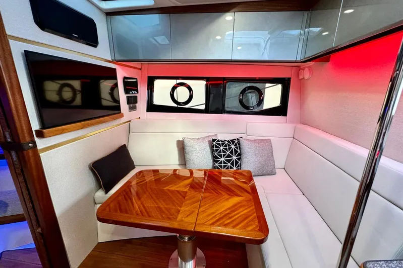 Days Ahead Yacht Photos Pics Luxurious interior of 2022 Boston Whaler 405 Conquest with elegant seating and wooden table.
