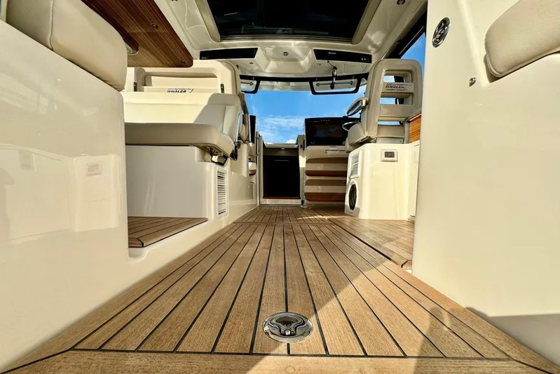 Days Ahead Yacht Photos Pics Interior view of 2022 Boston Whaler 405 Conquest boat with wooden flooring.