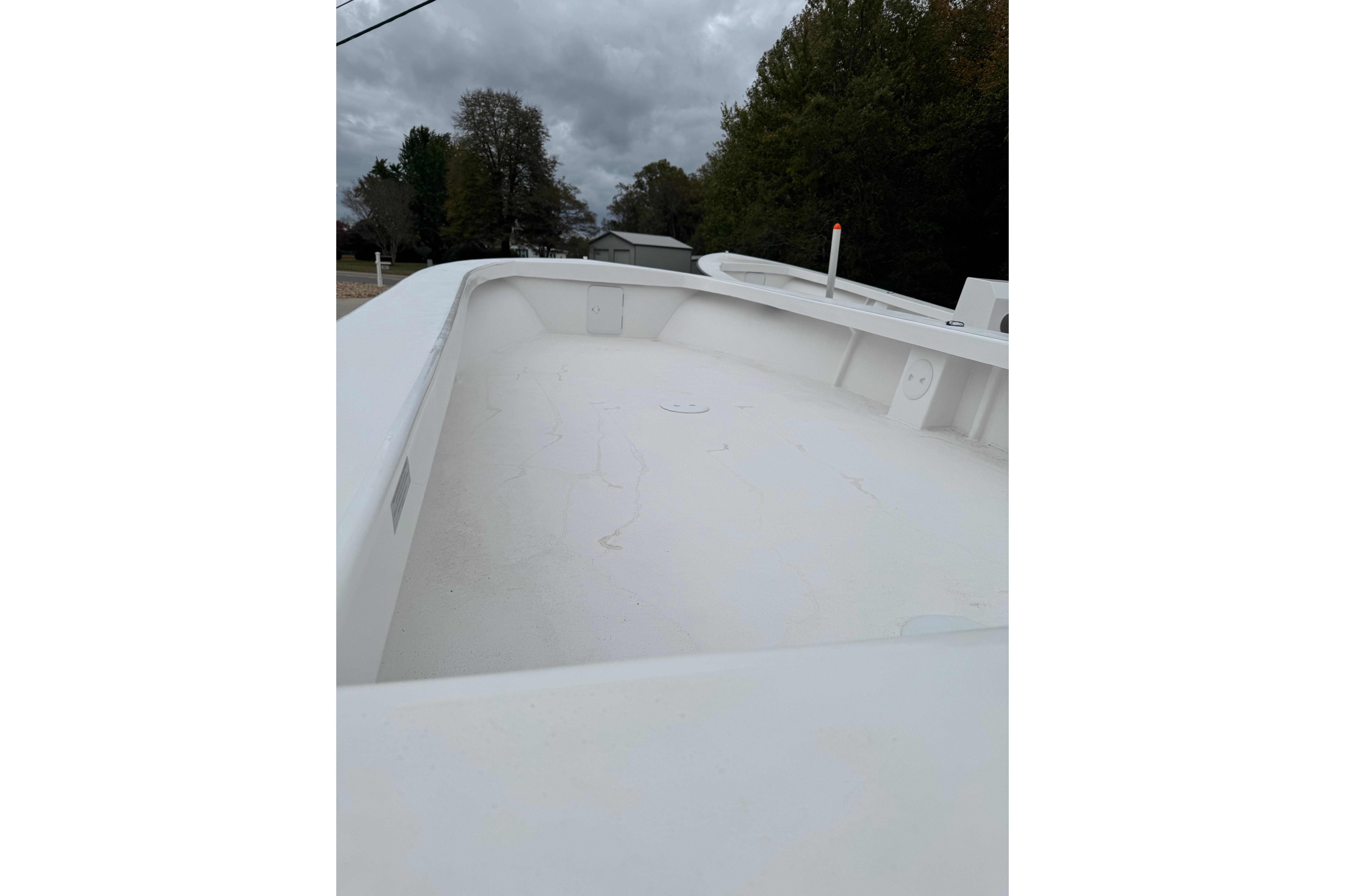 2026 C-Hawk 26 Center Console boat deck under cloudy sky.