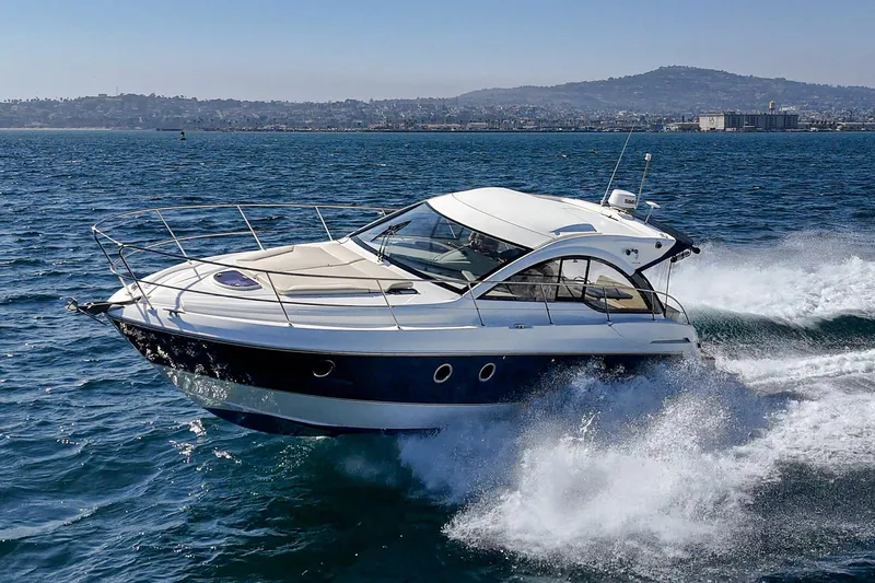  Yacht Photos Pics 2014 Beneteau Gran Turismo 38 yacht cruising on open water, scenic coastal backdrop.