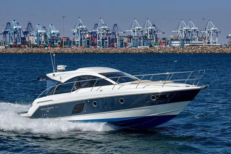  Yacht Photos Pics 2014 Beneteau Gran Turismo 38 yacht cruising near industrial port cranes.