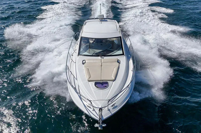  Yacht Photos Pics 2014 Beneteau Gran Turismo 38 yacht cruising on open water, aerial view.