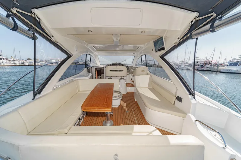  Yacht Photos Pics 2014 Beneteau Gran Turismo 38 yacht interior with spacious seating and wooden table.