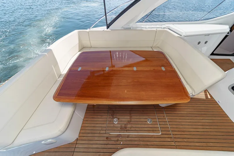  Yacht Photos Pics Luxury seating area on 2014 Beneteau Gran Turismo 38 yacht with wooden table.