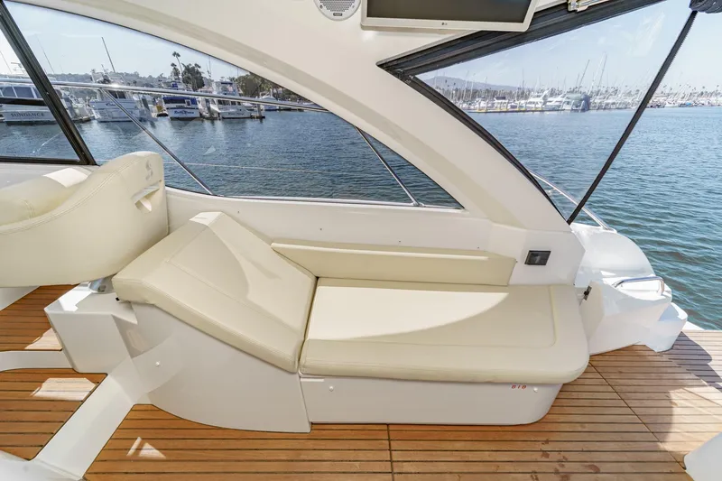  Yacht Photos Pics Interior of 2014 Beneteau Gran Turismo 38 yacht with beige seating and wooden deck.