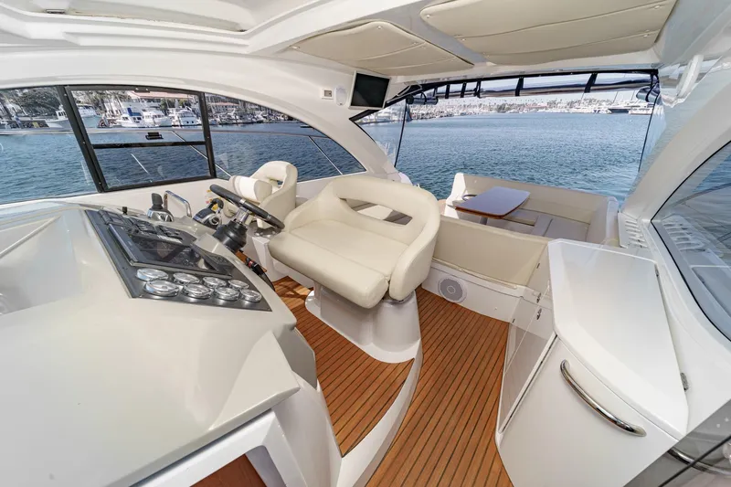 Yacht Photos Pics Interior of 2014 Beneteau Gran Turismo 38 yacht with helm and seating area.
