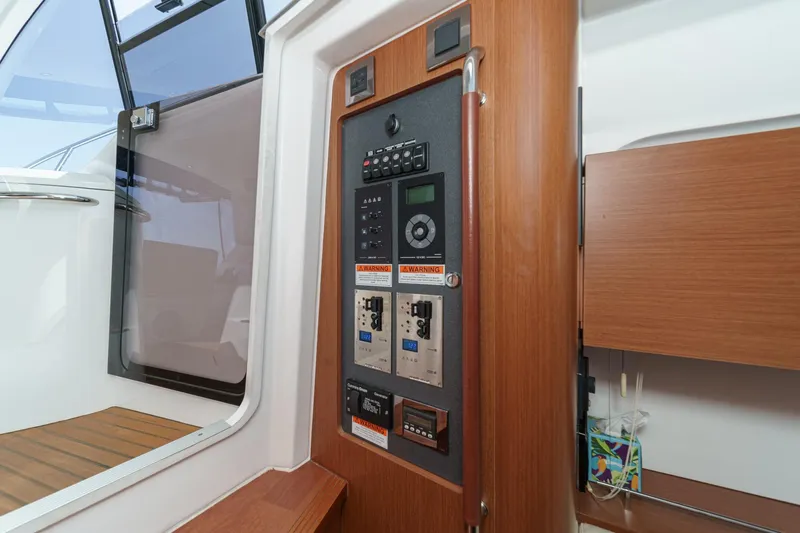  Yacht Photos Pics Control panel inside 2014 Beneteau Gran Turismo 38 yacht, featuring wood accents and modern design.