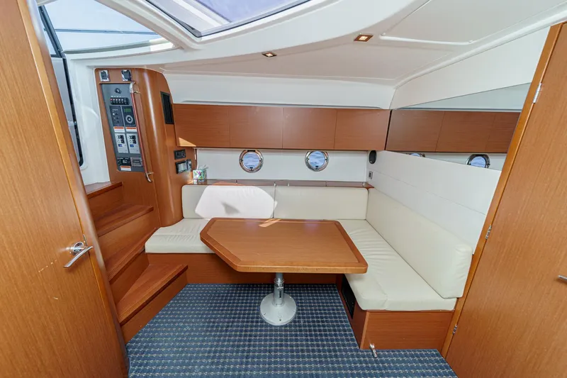  Yacht Photos Pics Interior of 2014 Beneteau Gran Turismo 38 yacht with cozy seating and wooden table.