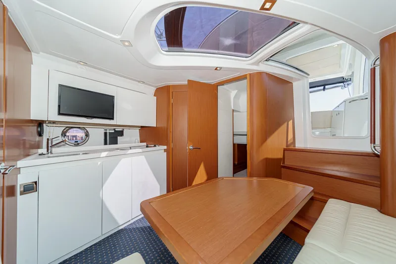  Yacht Photos Pics Interior of 2014 Beneteau Gran Turismo 38 yacht with modern wood finish and skylight.