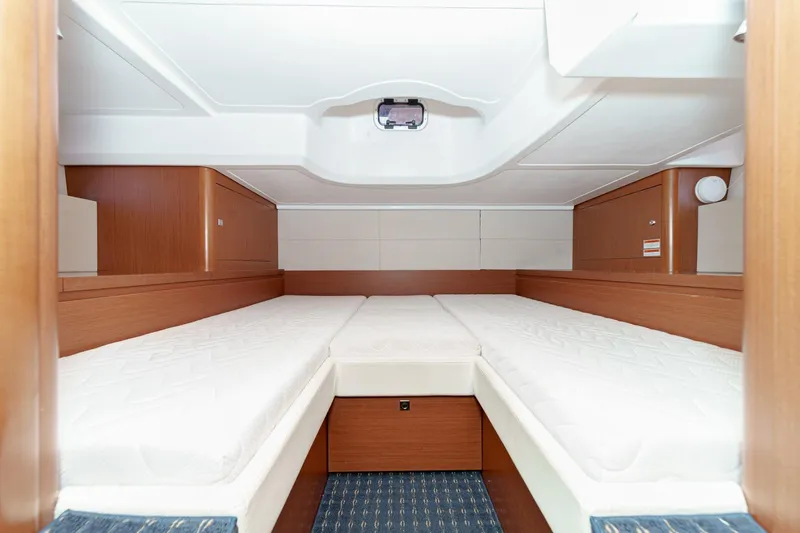  Yacht Photos Pics Interior cabin of 2014 Beneteau Gran Turismo 38 yacht with twin beds and wooden finish.