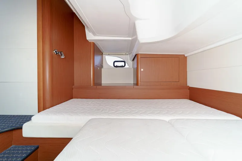  Yacht Photos Pics Interior cabin of 2014 Beneteau Gran Turismo 38 yacht with twin beds and wooden finish.