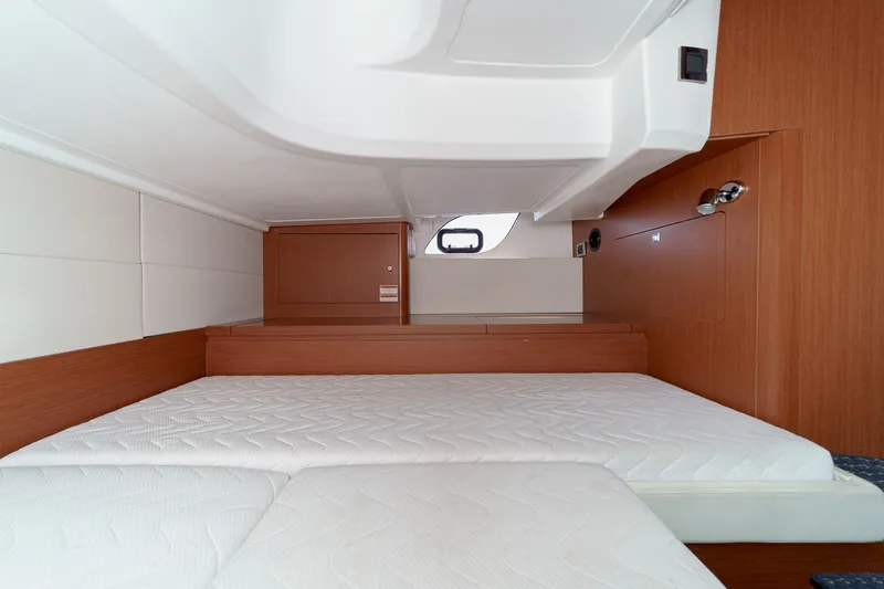  Yacht Photos Pics Interior cabin of 2014 Beneteau Gran Turismo 38 with wooden finish and comfortable bedding.
