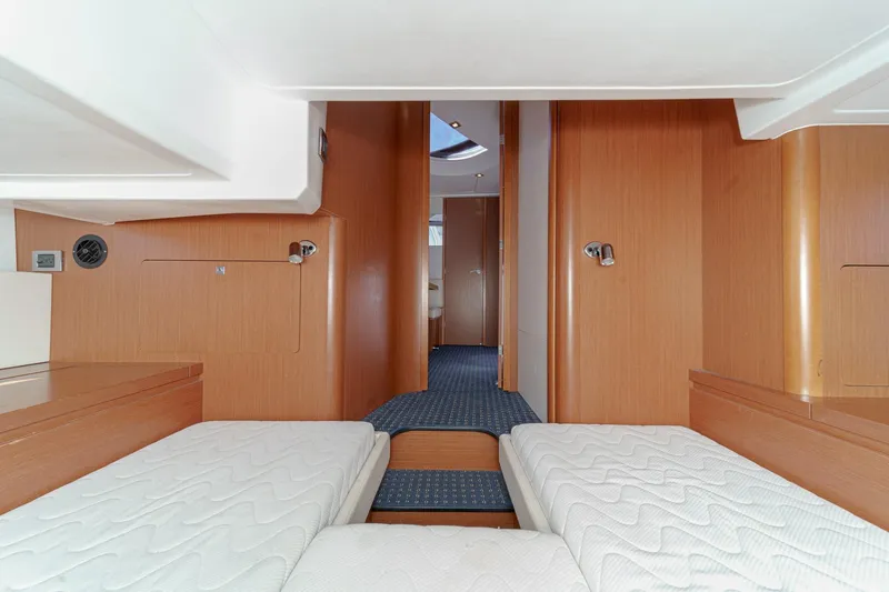  Yacht Photos Pics Interior of 2014 Beneteau Gran Turismo 38 yacht with twin beds and wooden finish.
