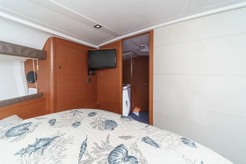  Yacht Photos Pics 2014 Beneteau Gran Turismo 38 cabin interior with TV and nautical-themed bedding.