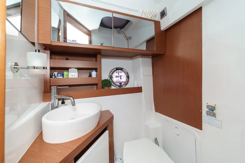  Yacht Photos Pics Luxurious bathroom in 2014 Beneteau Gran Turismo 38 yacht, featuring modern fixtures and wood accents.