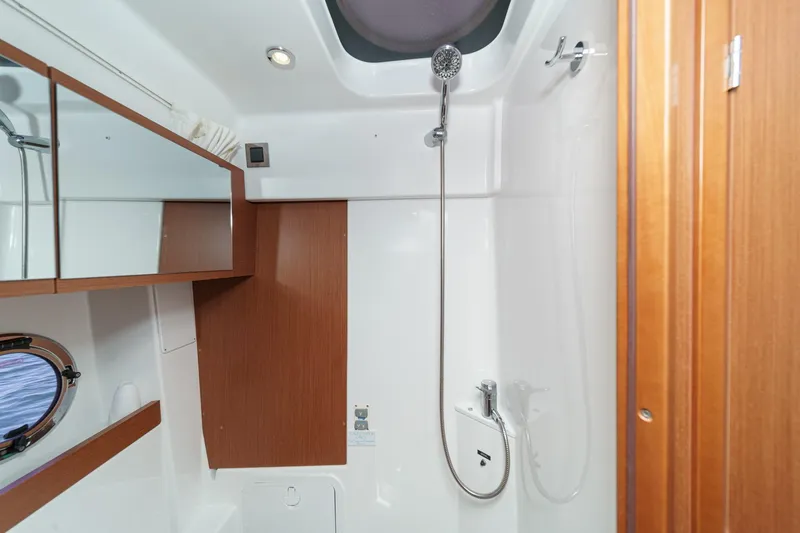  Yacht Photos Pics Bathroom interior of 2014 Beneteau Gran Turismo 38 yacht, featuring shower and wooden accents.