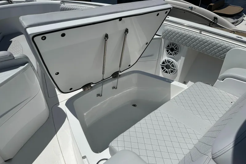  Yacht Photos Pics 2023 HCB 39 Speciale boat interior with open storage compartment and quilted seating.