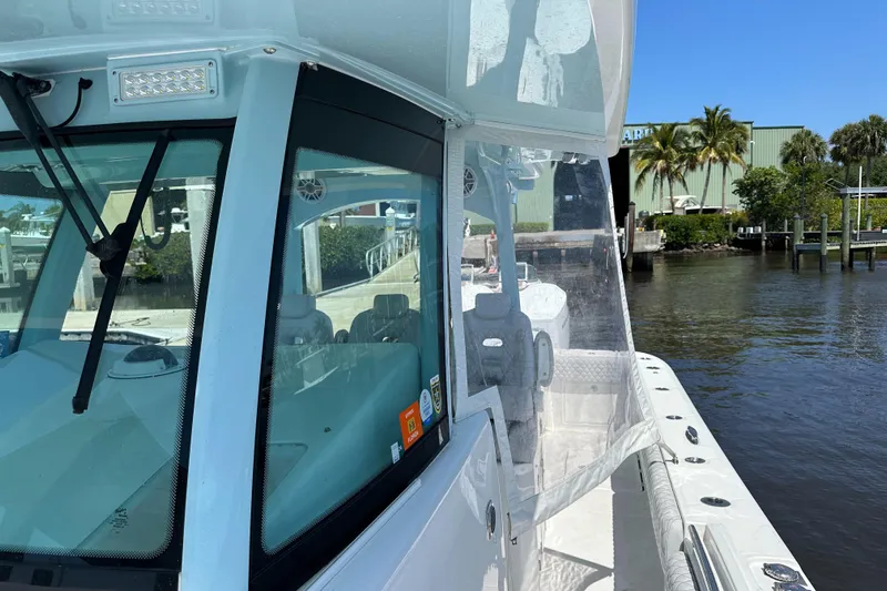  Yacht Photos Pics 2023 HCB 39 Speciale boat docked by a waterfront, clear skies.