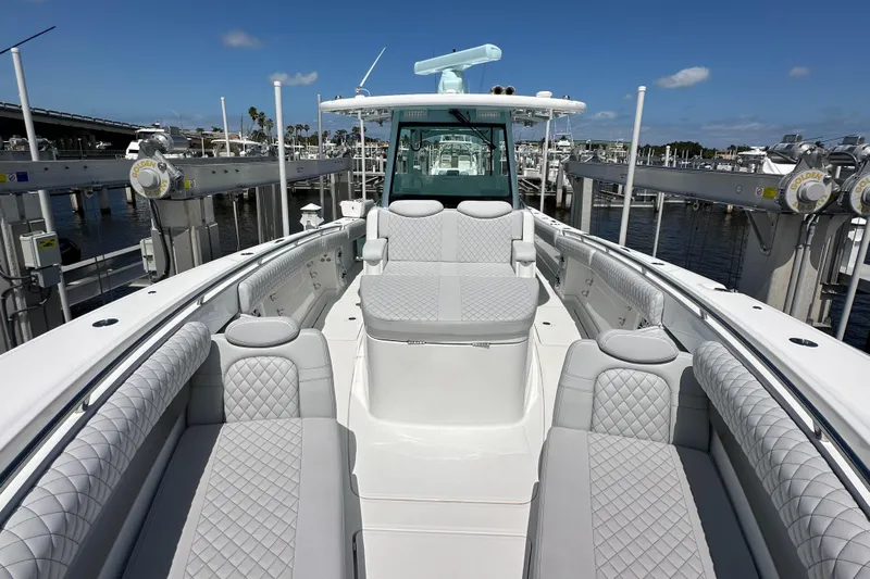  Yacht Photos Pics 2023 HCB 39 Speciale boat with luxurious seating and sleek design at a marina.