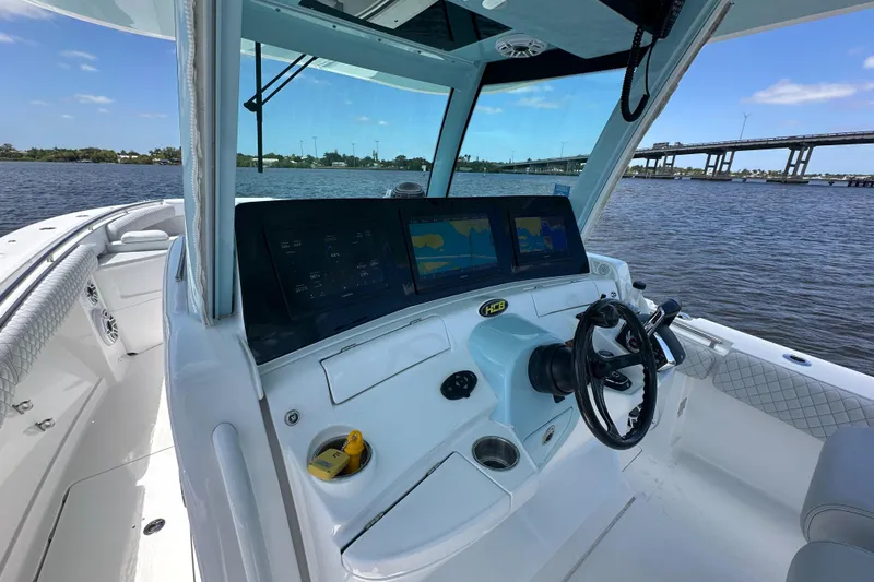  Yacht Photos Pics 2023 HCB 39 Speciale boat cockpit with advanced navigation system on a sunny day.