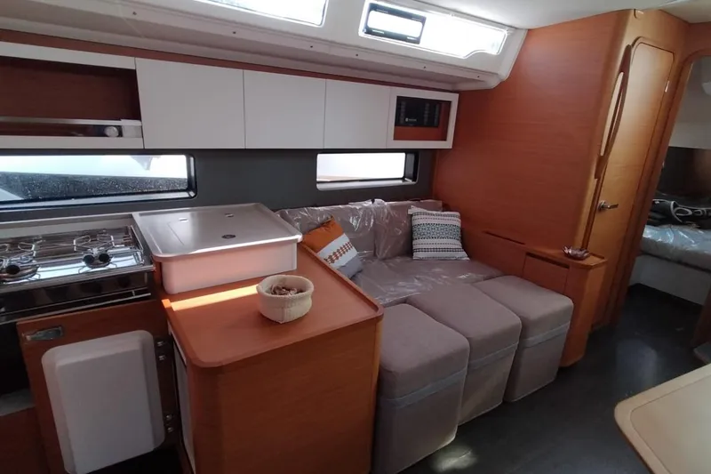  Yacht Photos Pics 2024 Dufour 44 yacht interior with modern kitchen and cozy seating area.