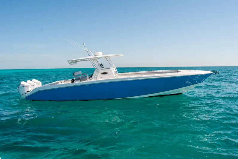  Yacht Photos Pics A sleek blue IMG 40 boat cruising on clear turquoise waters, 2021 model.