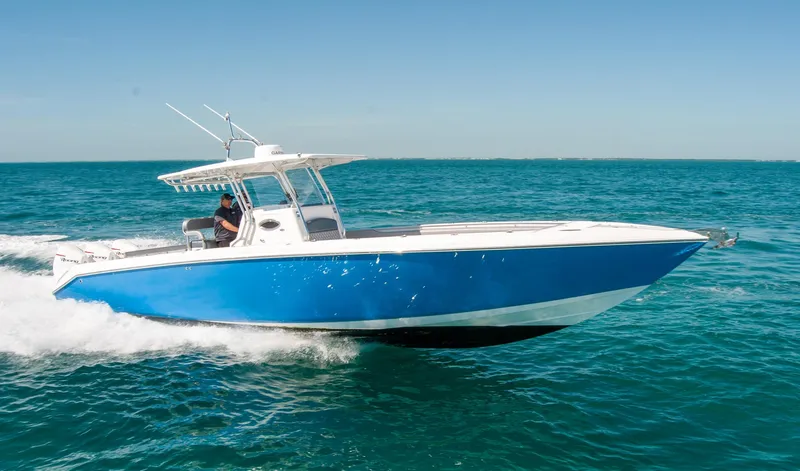  Yacht Photos Pics A sleek blue IMG 40 boat cruising on clear ocean waters, 2021 model.