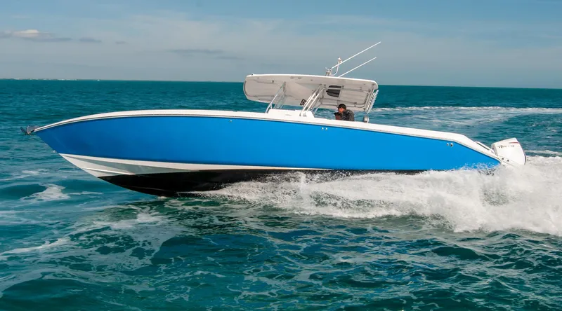  Yacht Photos Pics A sleek blue IMG 40 speedboat cruising on open water, 2021 model.