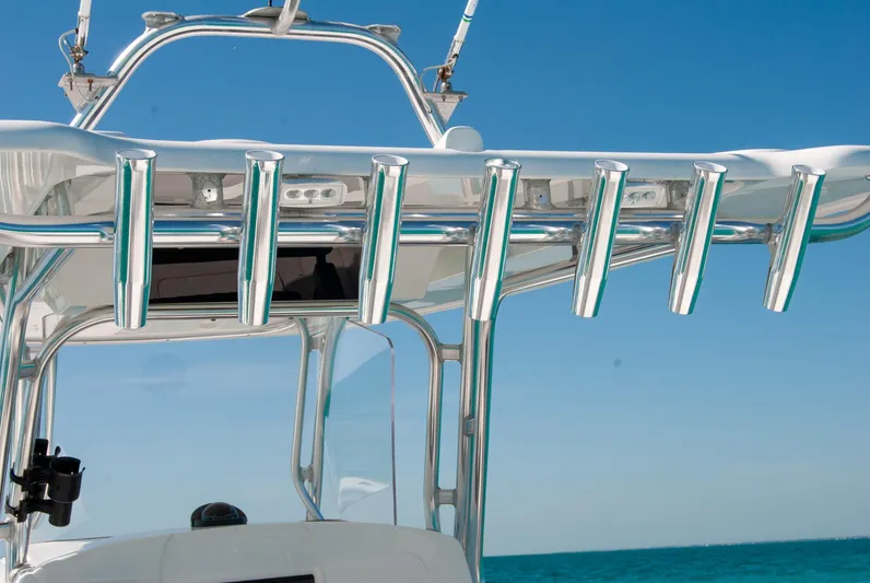  Yacht Photos Pics Boat's stainless steel rod holders against a clear blue sky and ocean backdrop.