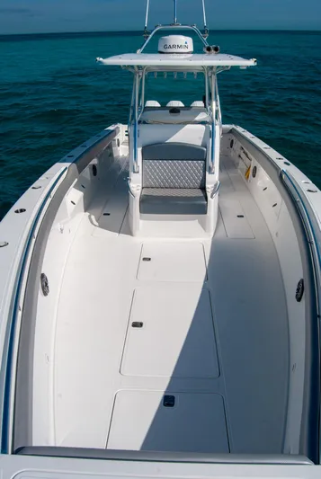  Yacht Photos Pics Center console boat on clear blue water, featuring spacious deck and Garmin equipment.